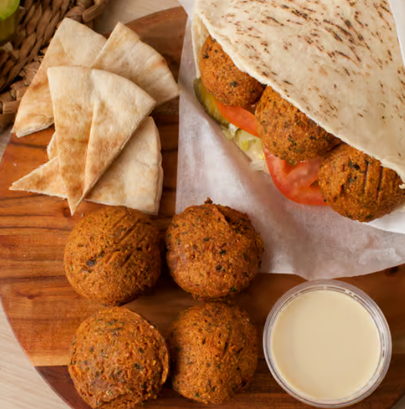 A spread of burgers, fries, falafel, and sandwiches