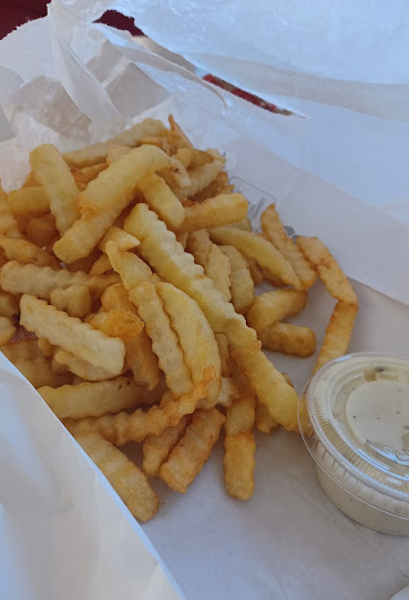 Basket of crinkle-cut fries with a side of ranch