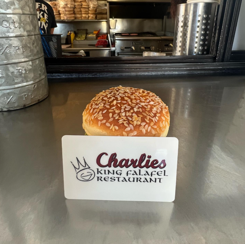 Charlies branded gift card in front of a burger bun