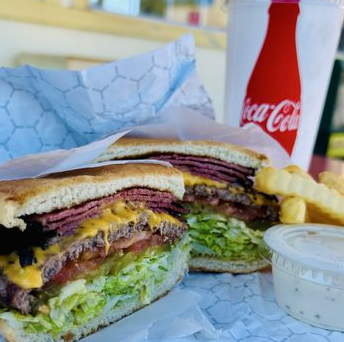 Pastrami sandwich with crinkle fries and a soda